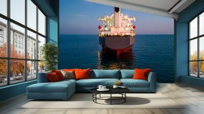 A massive cargo ship wood chips carrier in the sea, aerial view Wall mural