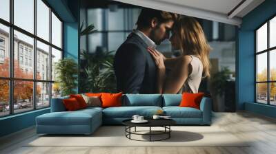 A pair of office workers embracing in an empty office, the concept of a workplace romance Wall mural