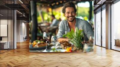 Happy man dining at an outdoor restaurant Wall mural