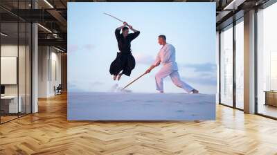 Men attack each other with a traditional Japanese weapon Wall mural