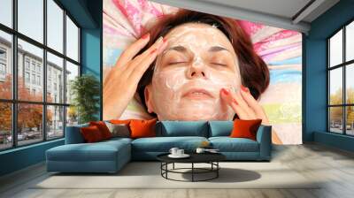 cream on the face of a woman Wall mural