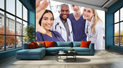 Team of doctors take a selfie together after success in the surgery emergency room in a hospital office. Happy, teamwork and young healthcare workers ready to help people with medical treatment Wall mural