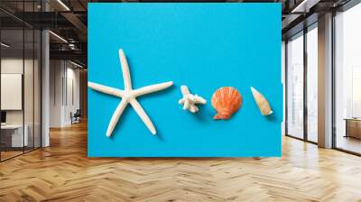 Shellfish and starfish on blue background. summer marine decoration. flat lay, top view, copy space Wall mural