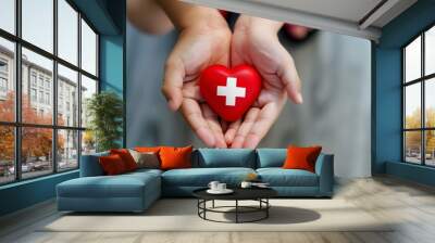 world red cross day, adult and child hands holding red heart, healthcare, love and family insurance concept Wall mural