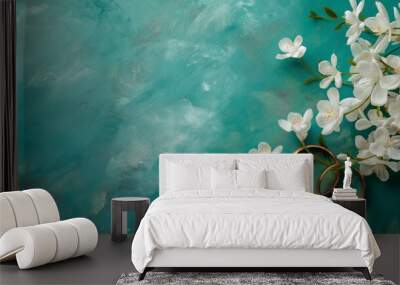  On the light blue turquois substrate two golden wedding rings decorated with white flower, close up. A romantic concept. Wall mural