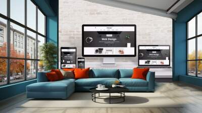 multiple display devices with modern flat design web site presentation. wooden desk and brick wall i Wall mural