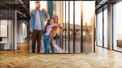 Cheerful family enjoying in shopping together Wall mural