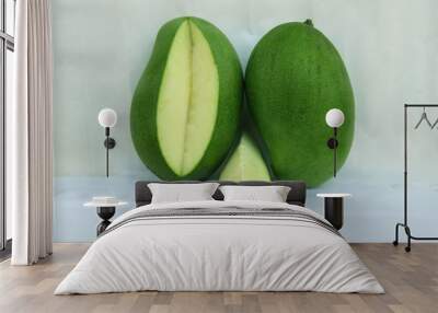 green raw mango and slice on white background in summer time Wall mural