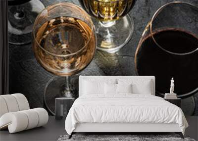 Glasses with  red ,white  and rose wine on black marble background. View above.  Copy space. Wall mural