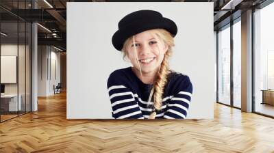 Cute and sassy style. Portrait of a cute girl giving you a toothy smile. Wall mural