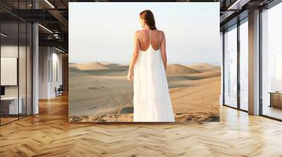 beautiful brunette in white dress fashion on sand Wall mural