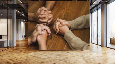 christian and prayer Group of christians holding hands praying together to believe and bible on wooden table for prayer meeting. Wall mural