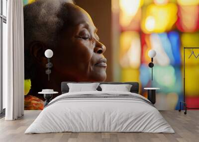 Elderly black woman praying in church Wall mural