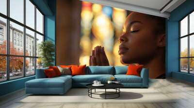 Young black woman praying in church Wall mural