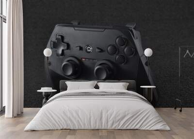 a black console controller with a black background Wall mural