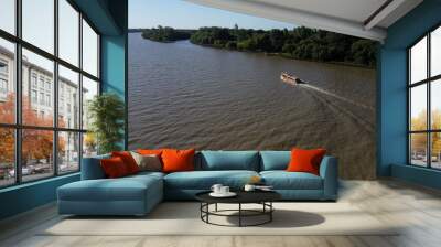 Tourist boat sailing through amazon river during sunny day. Wall mural