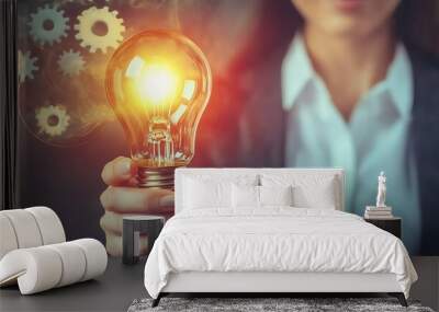 Woman holding glowing light bulb, creative idea Wall mural