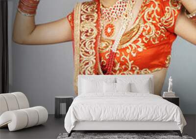 Pretty Indian bride with heavy makeup and traditional Indian bridal attire showing peace gesture Wall mural