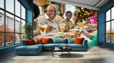 A multigenerational family sitting around a festive dinner table, enjoying a traditional holiday feast with laughter and warmth Wall mural