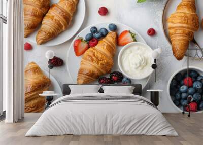 Top view of a breakfast table with croissants, fruit, yogurt, and coffee, showcasing a balanced morning meal Wall mural