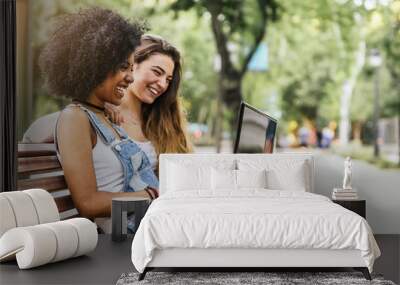 Beautiful women using a laptop in the Street. Wall mural