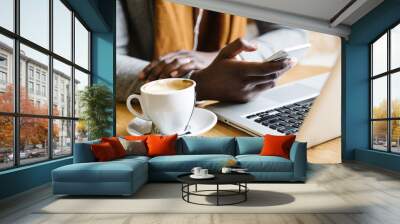 businessman using his laptop in the cofee shop. Wall mural