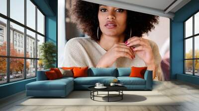 Portrait of attractive afro woman in coffee shop Wall mural