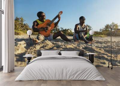 Two cuban friends having fun in the beach with his guitar. Wall mural