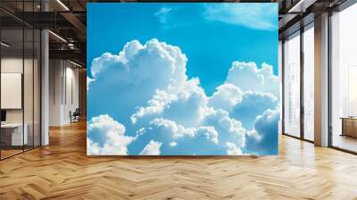 Beautiful blue sky with fluffy white cumulus clouds, a stunning view of nature's artistry. The clouds represent hope, freedom, change, and a sense of peace. Wall mural