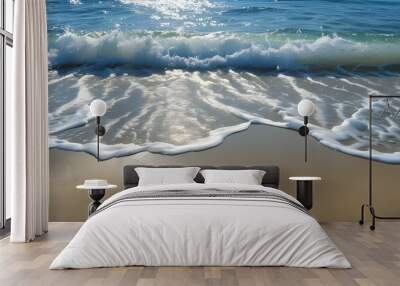 Serene beach vista with light sand contrasting against the shimmering ocean waves Wall mural