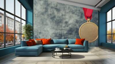 A gold medal with a red ribbon hangs against a textured backdrop, symbolizing achievement and recognition. Wall mural