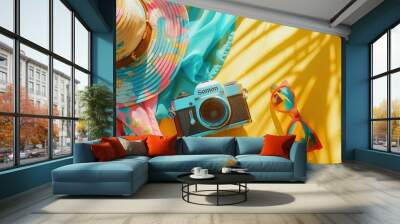 Lively, colorful flatlays that are essential for summer: wide-brimmed hats, sunglasses, and colorful scarves. and digital cameras All arranged against a bright yellow background. Wall mural