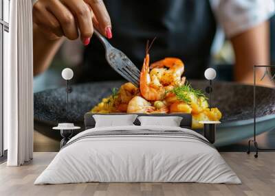 An Afro-Latina chef plating a Puerto Rican mofongo dish, made of mashed plantains and garlic, topped with shrimp, in a vibrant restaurant kitchen. Hispanic heritage month tradition Wall mural