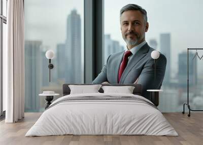 Middle-aged Caucasian male consultant in a gray suit and red tie, standing in front of a floor-to-ceiling window with a city skyline view, arms crossed. Creative director. Planning, production stylist Wall mural