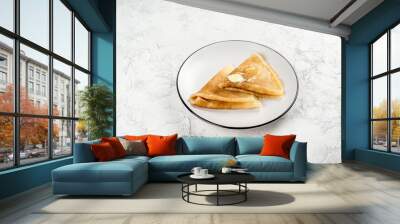 Two pancakes on a round, white plate. Close-up shot Wall mural