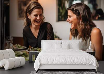  Two female best friends eating healthy food while sitting together on a restaurant terrace on a summer day Wall mural