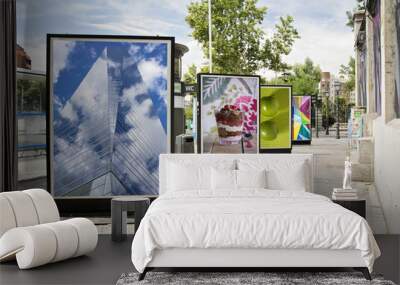 billboards with photographs at city street Wall mural