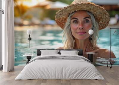 Fit active senior smile woman with hat enjoying retirement inside the swimming pool and looking at camera, Happy senior healthy old woman enjoying active lifestyle Wall mural