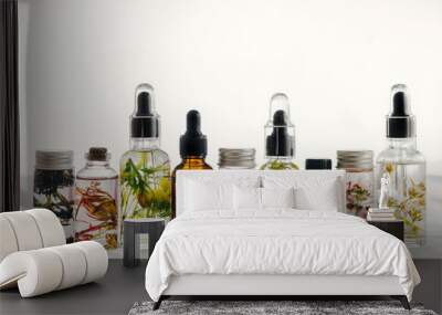 Transparent Bottles of essential oil with fresh herbs. Wall mural