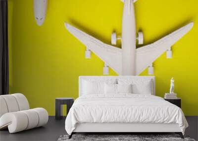 Two jet airplane on yellow background. Travel around the world. Wall mural