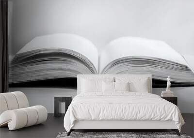 An open book isolated on a white background Wall mural