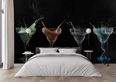 Cocktail glasses with colorful alcoholic drinks splashing on a black background Wall mural