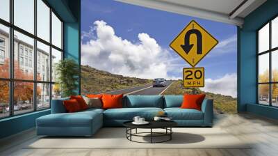 Mountain road with traffic signs Wall mural