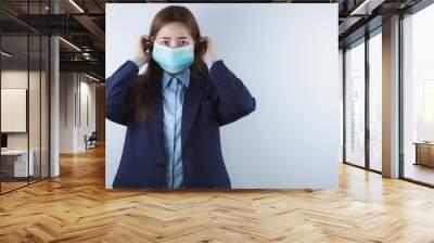 The business woman wearing protection face mask against coronavirus, PM 2.5 and cold. Coronavirus and Air pollution pm 2.5 concept. Wall mural