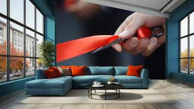 Hand Cutting a Ribbon: A hand holding scissors, cutting through a red ribbon during a grand opening ceremony.
 Wall mural