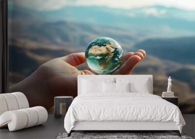 Hand Holding a Miniature Earth: A hand holding a small, miniature Earth, with a blurred background of a vast landscape, emphasizing the fragility of the planet. 
 Wall mural