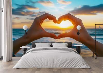 Heart Shape Hand Gesture: Two hands forming a heart shape with a sunset beach scene in the background.
 Wall mural