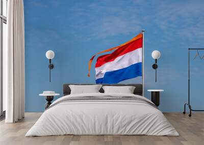 National holiday King’s Day or Koningsdag in Dutch, Due to Coronavirus disease (COVID-19) scourge, Celebrations will not take place this year, Netherlands and orange flag in the air with blue sky. Wall mural