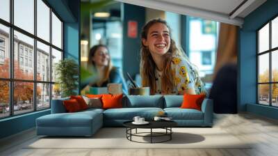 Young Woman Laughing with Friends in a Cozy Cafe Wall mural