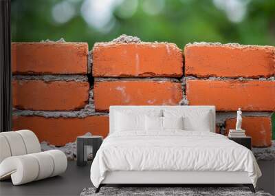 Closeup of red brick wall under construction with mortar Wall mural